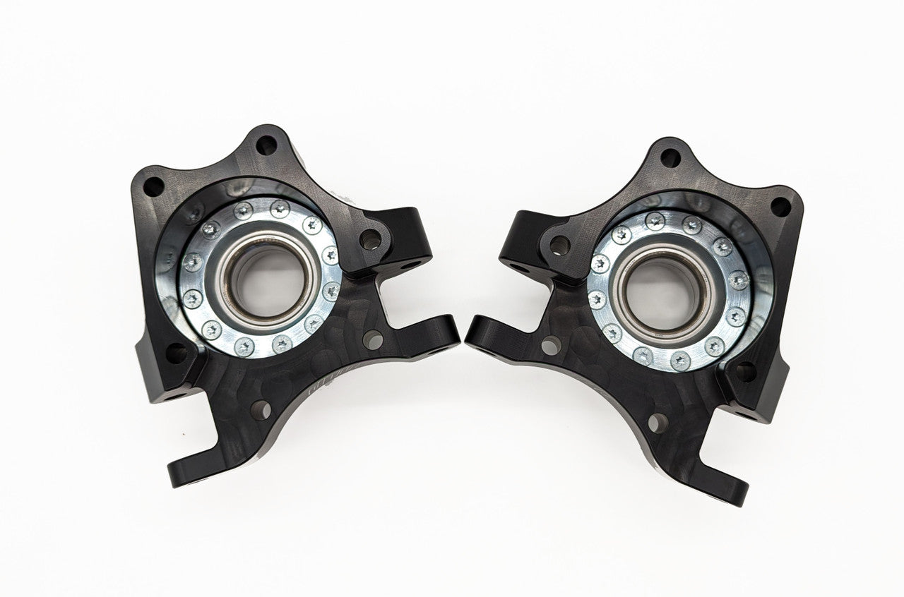Rear bearing carrier with steel ring fastened inside to prevent bearing push out on Polaris RZR XP 1000.